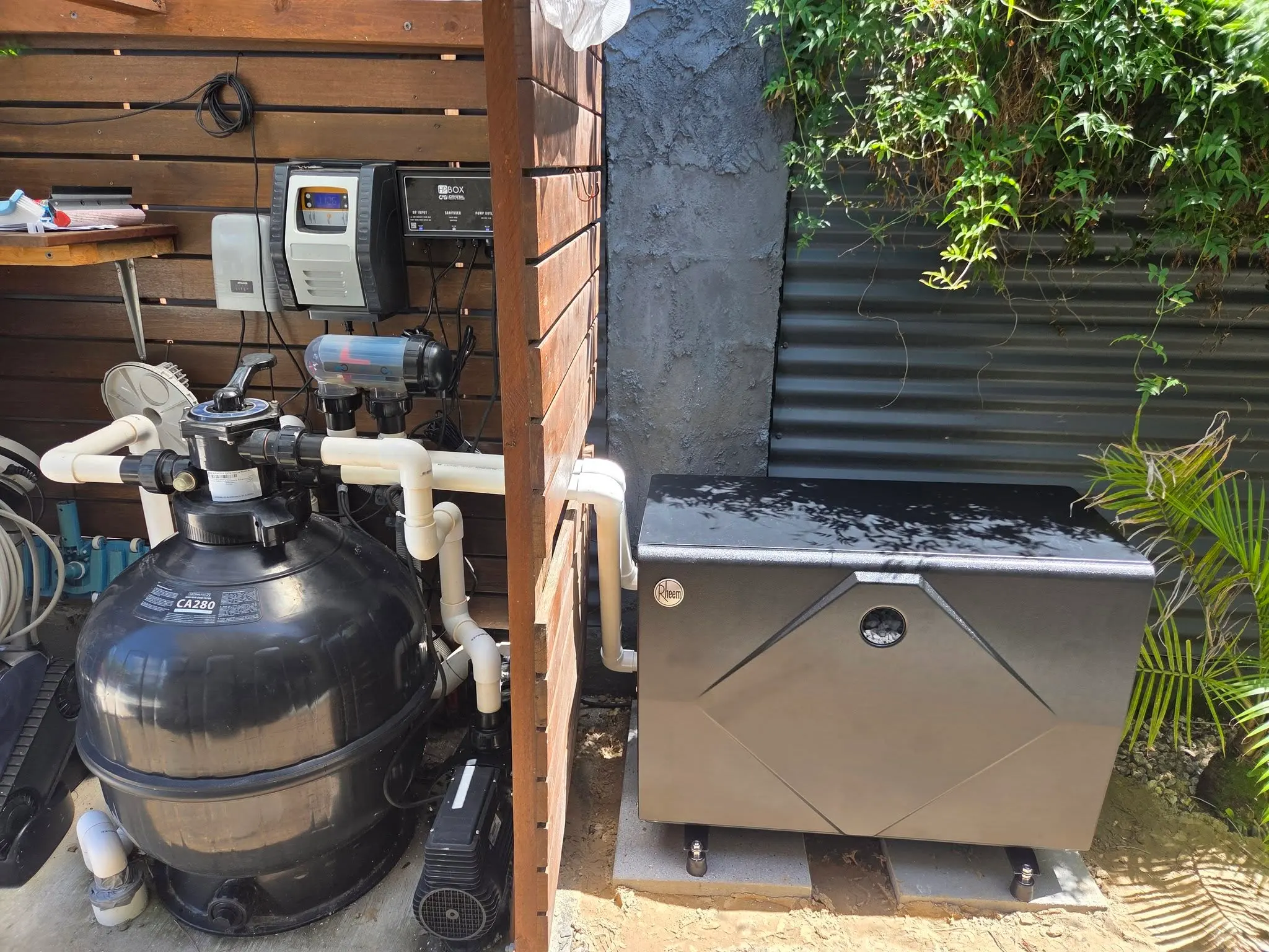Installed Rheem pool heater alongside filtration system